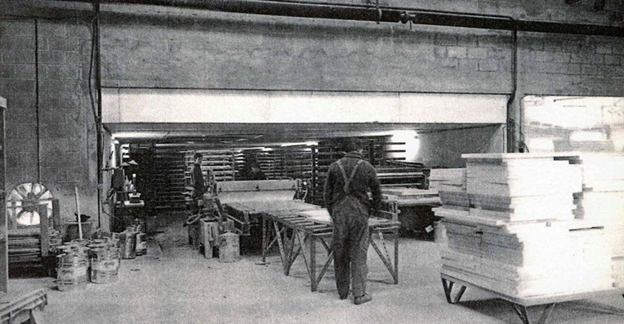 Archive photograph of the Dagard workshop with staff and stacked panels