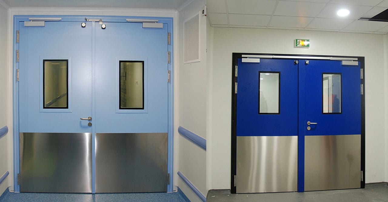 Two pairs of cleanroom double doors with vision panels and stainless kick plates