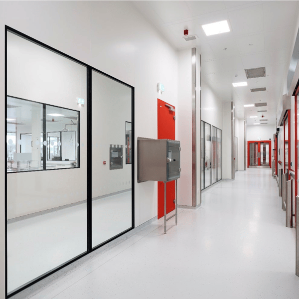 Cleanroom corridor with red doors and glazed partitions