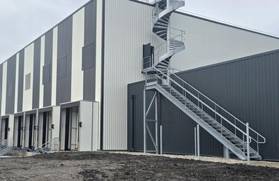Exterior of a new industrial building with an external spiral staircase